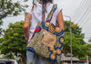 Person with a colorful backpack walking on a street